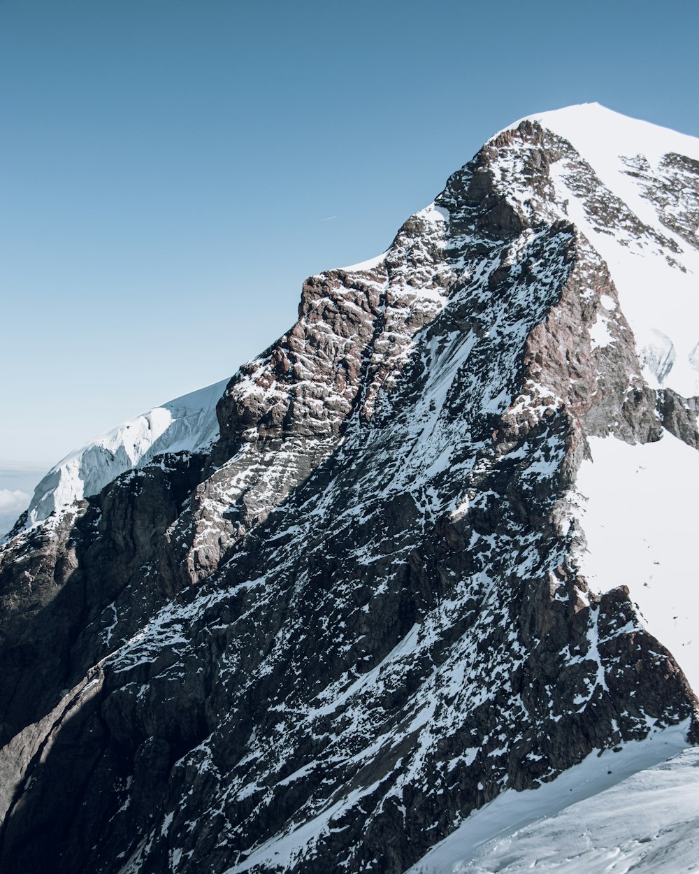 snow covered mountain under blue sky during daytime