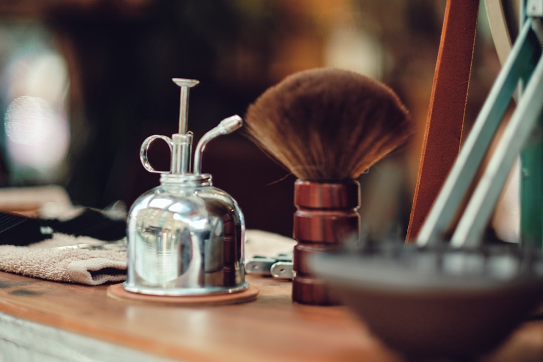 silver and gold perfume bottle beside silver and gold perfume bottle