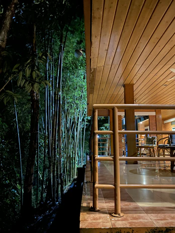A bamboo yoga deck surrounded by lush green tropical foliage