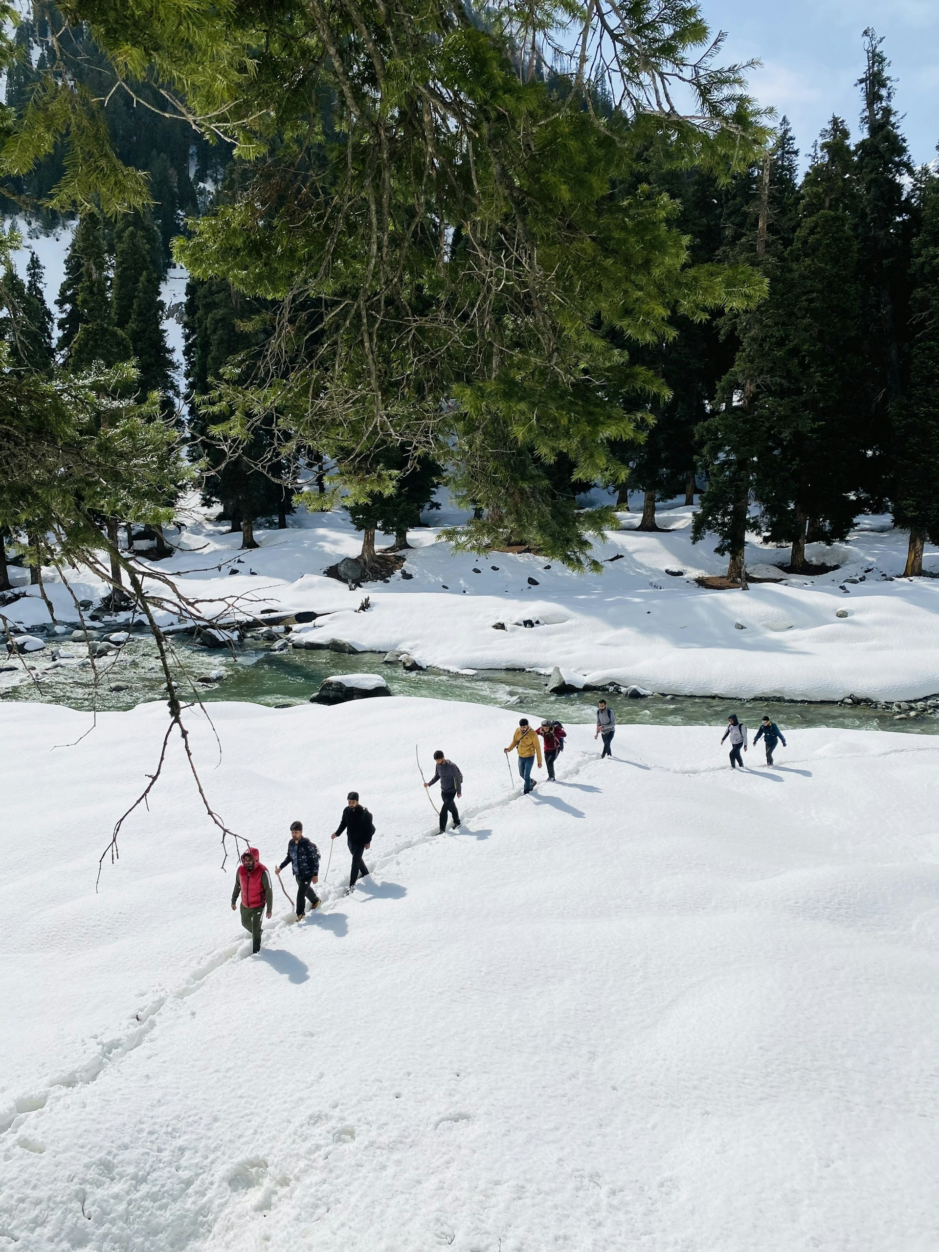people playing ice hockey on snow covered field during daytime