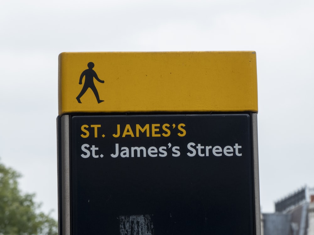 a street sign with a man walking across it