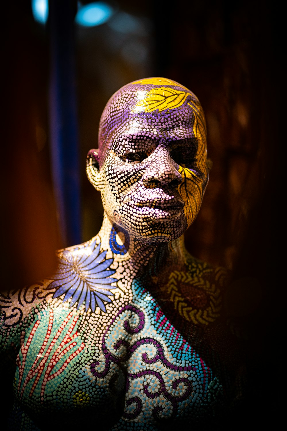 woman with yellow and blue face paint