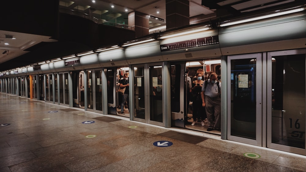 people walking on brown floor tiles