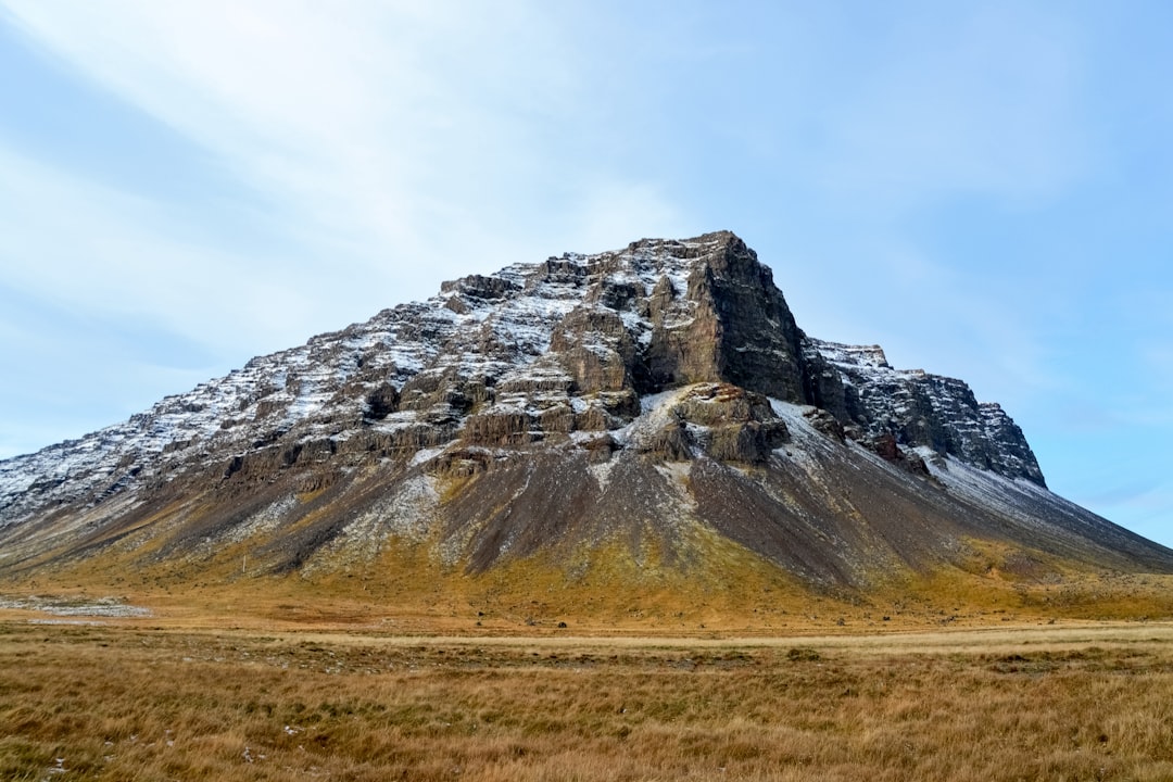 brown and gray rocky mountain under white cloudy sky during daytime