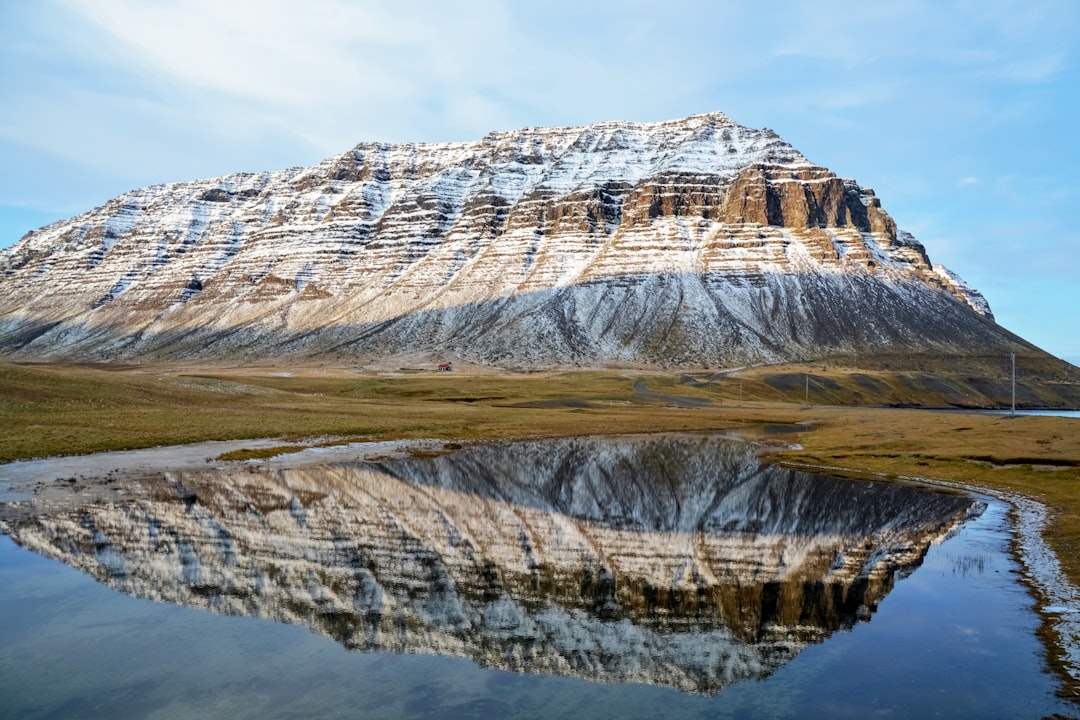 brown and white mountain under white clouds during daytime