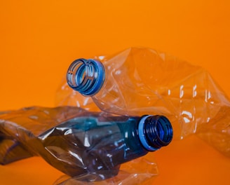 blue plastic bottle on orange surface