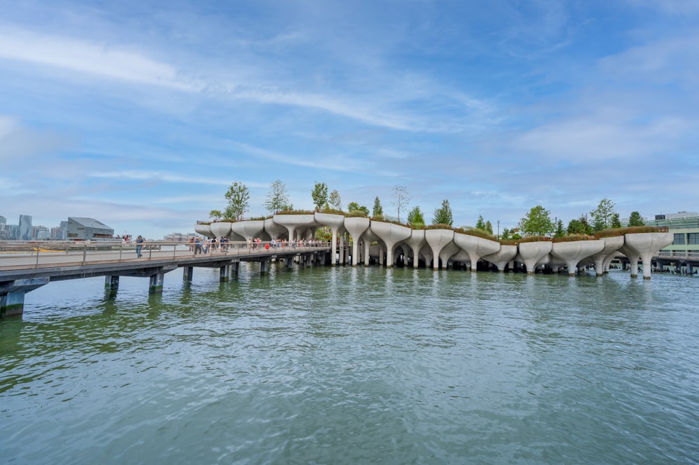 gray concrete bridge over body of water during daytime