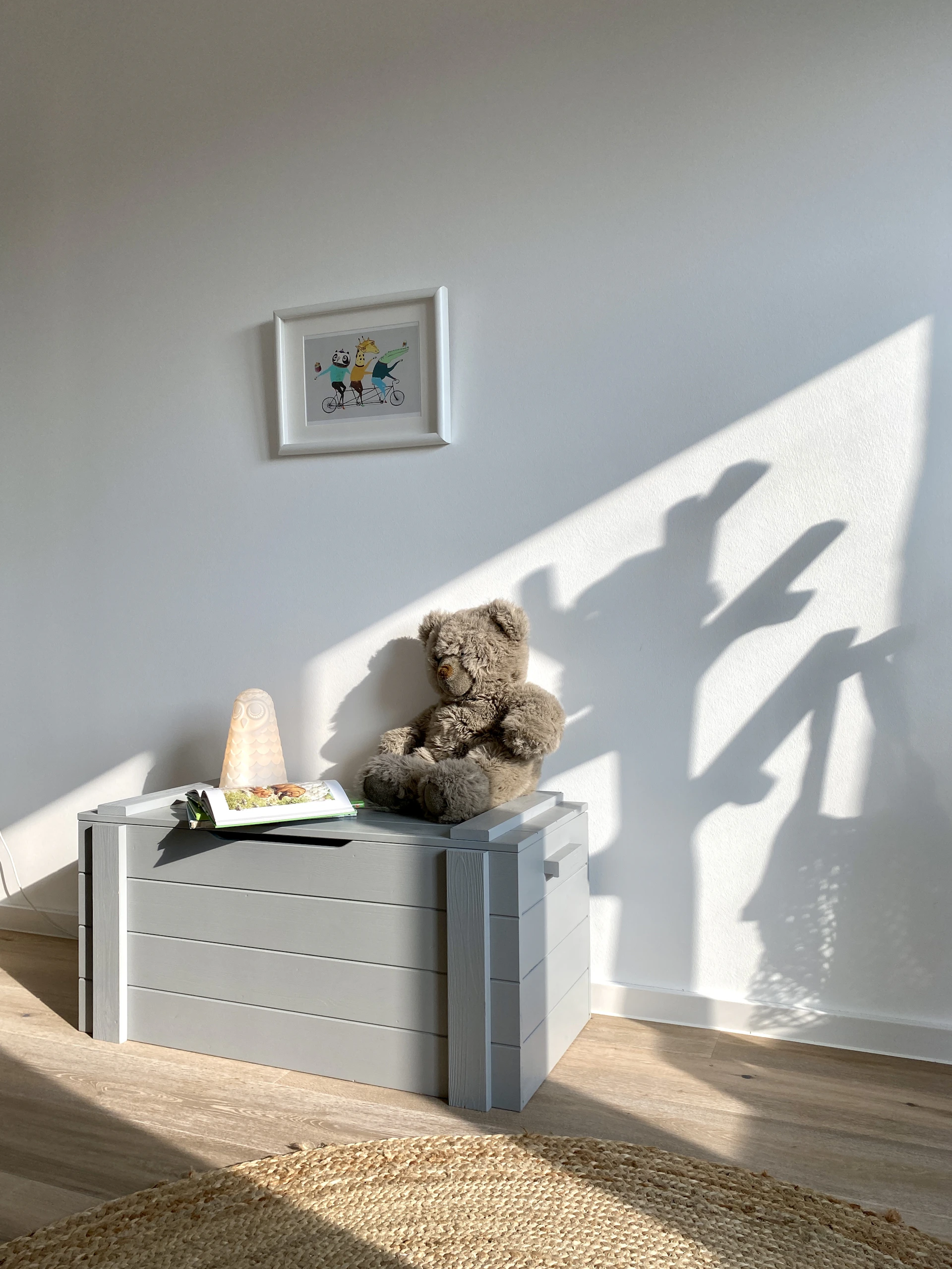 brown bear plush toy on white wooden shelf