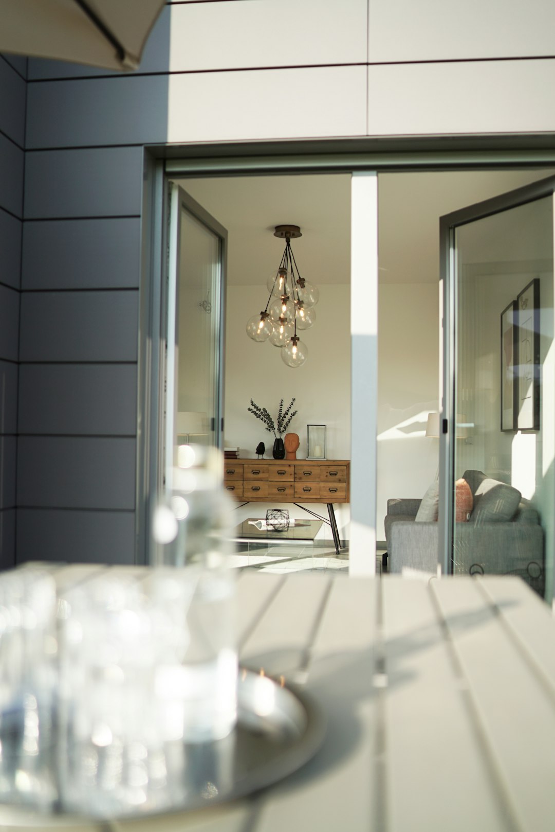 white wooden table near glass window