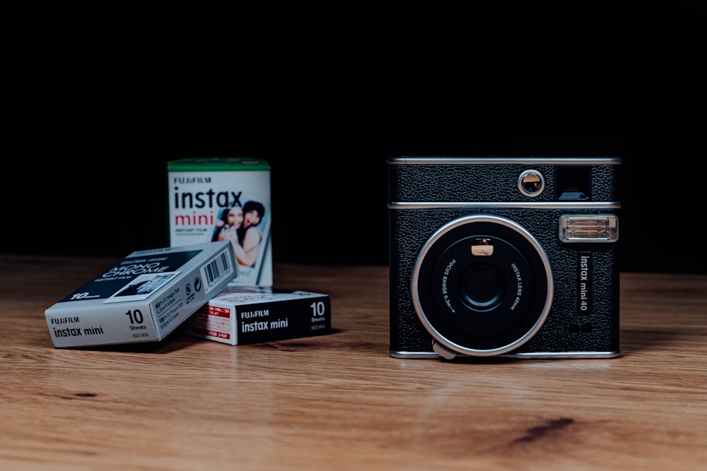 black and silver camera on brown wooden table