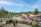 An outdoor public space with vibrant, culturally inspired benches and planters under warm sunlight.