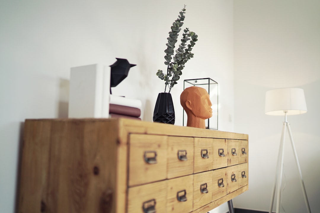 brown ceramic vase on brown wooden drawer