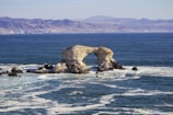 gray rock formation on blue sea during daytime