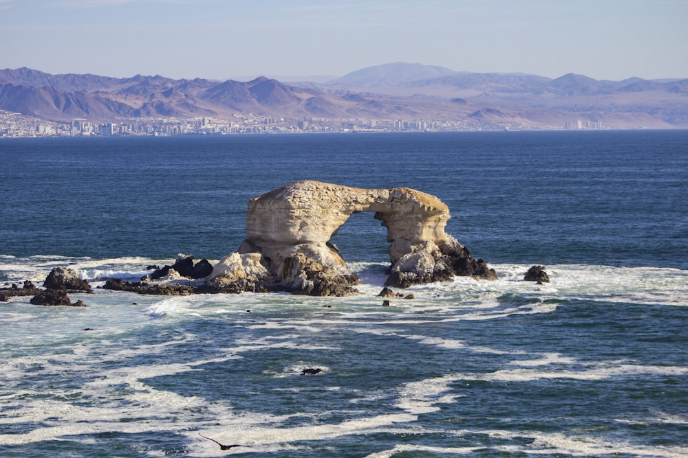 gray rock formation on blue sea during daytime