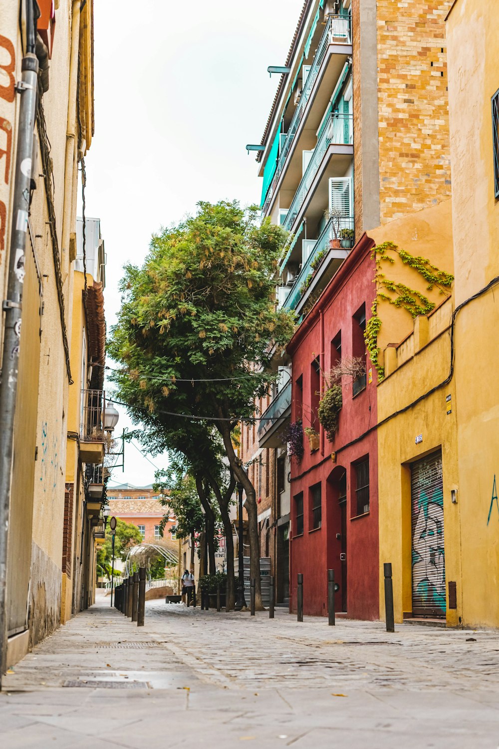 people walking on sidewalk near buildings during daytime