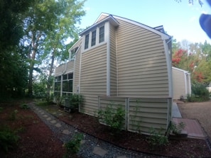 An outdoor view of a home on Staten Island surrounded by trees.