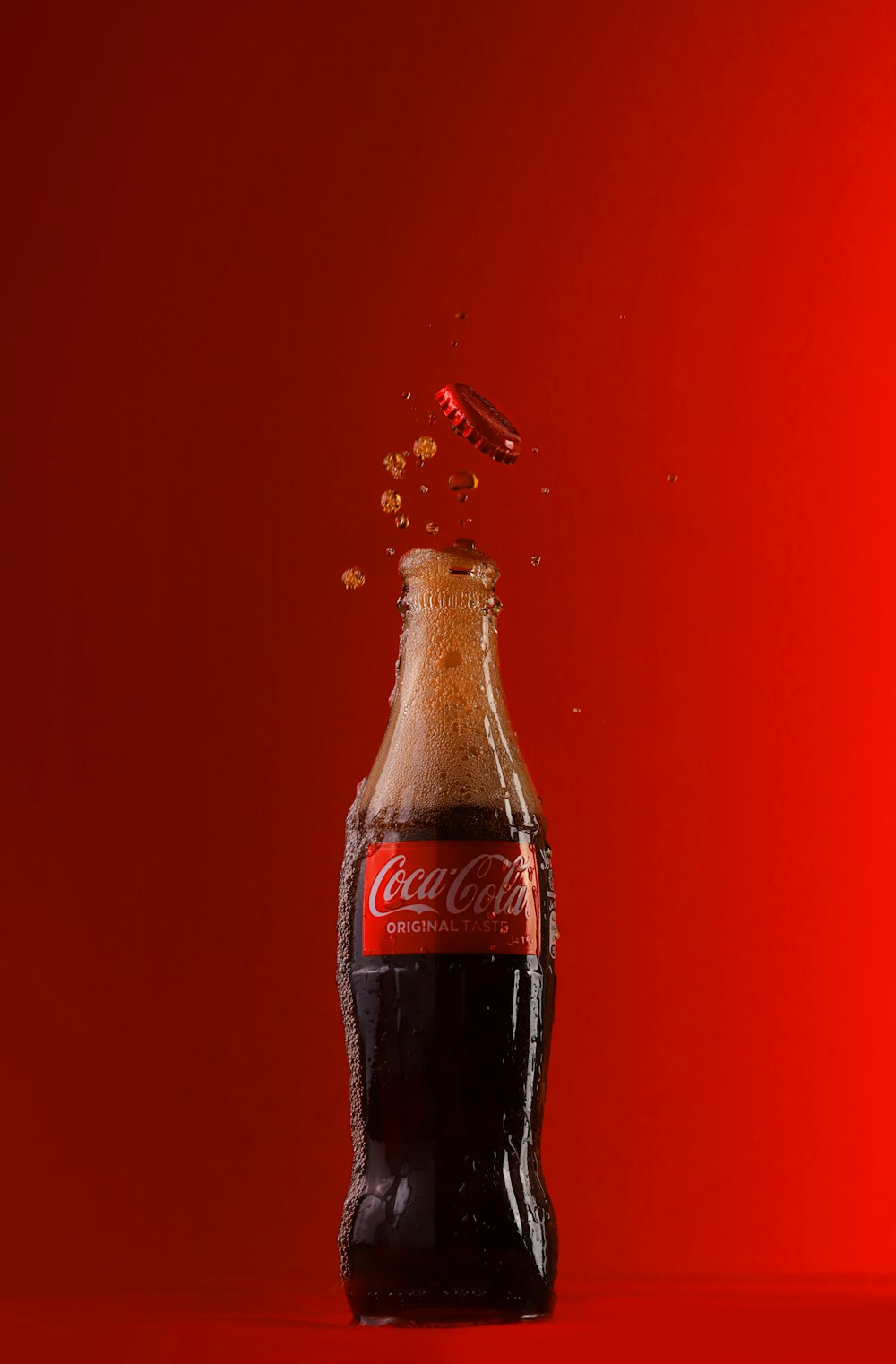 coca cola bottle on red textile