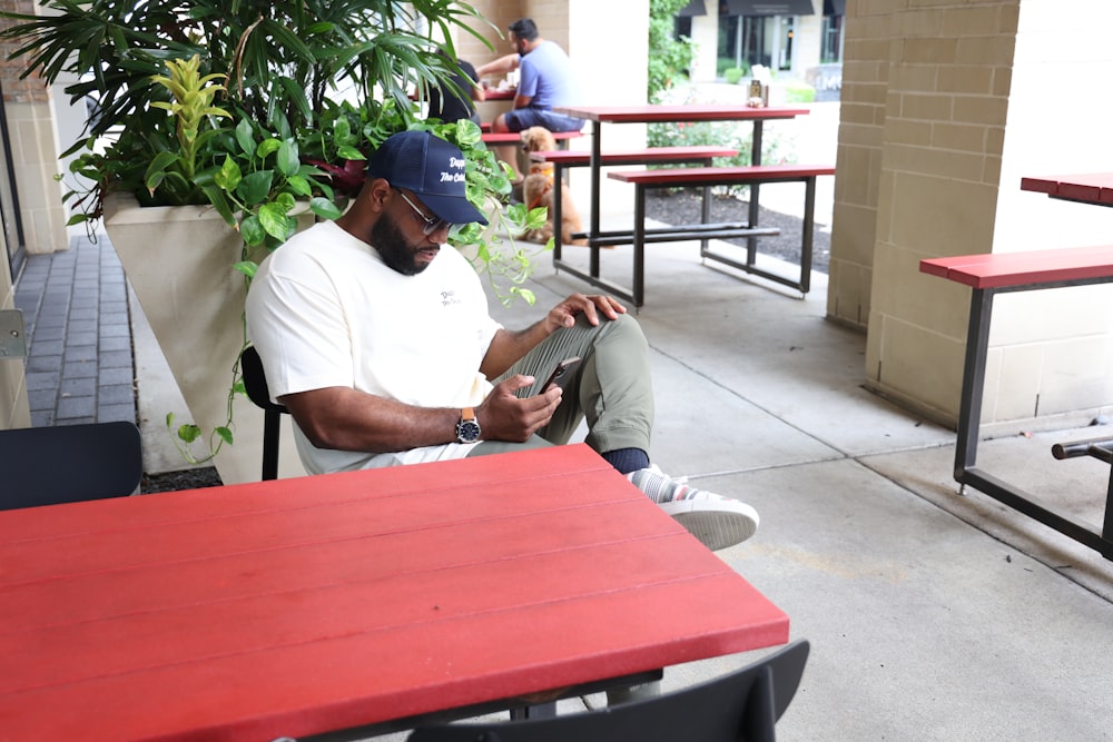 man in white t-shirt sitting on chair