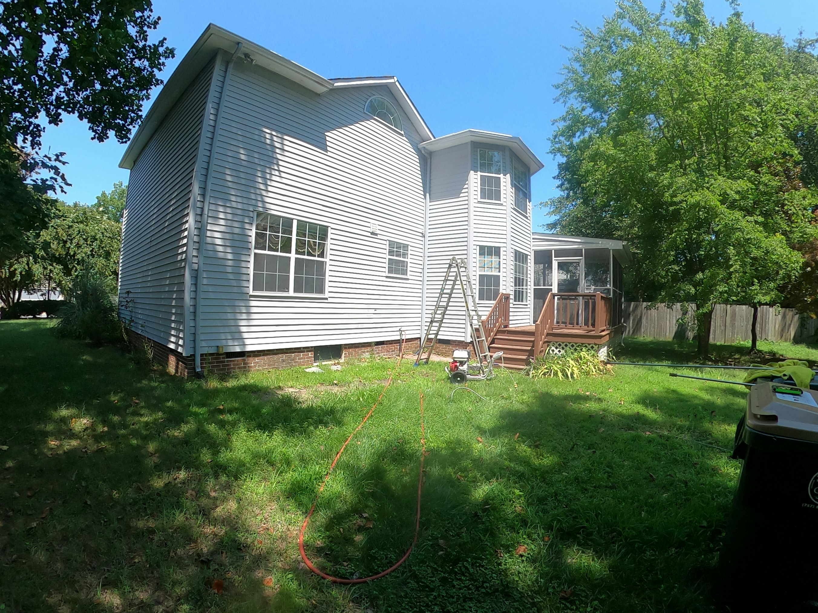 white and brown wooden house near green trees under blue sky during daytime
