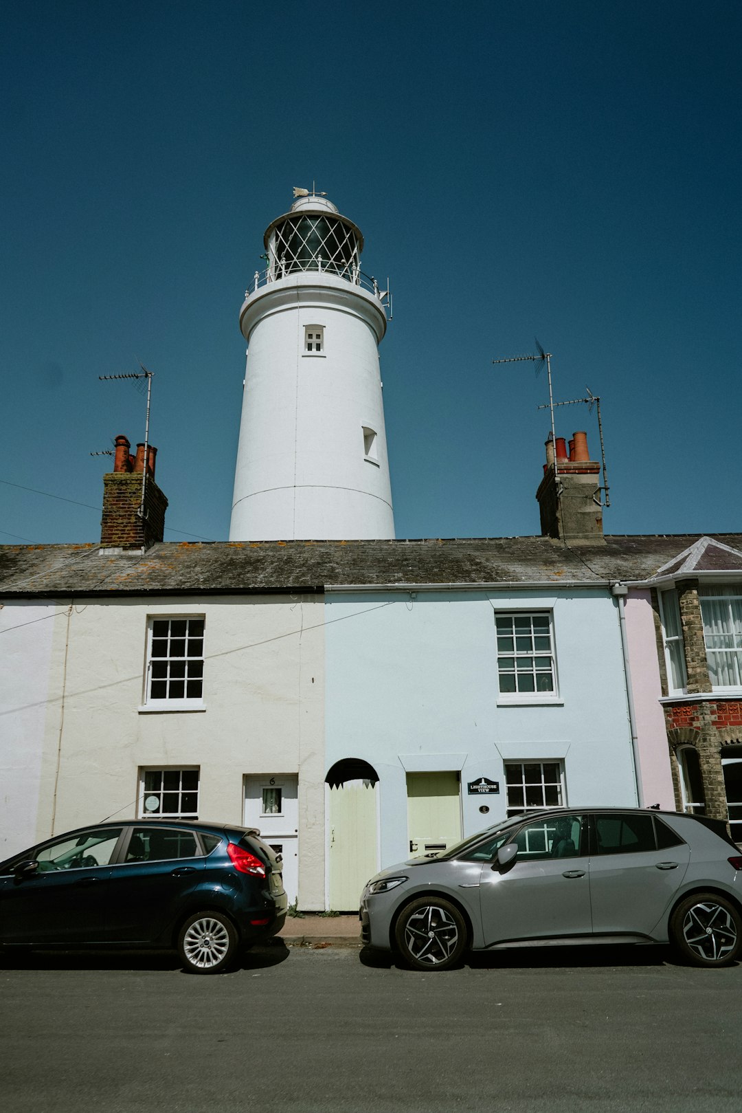 white concrete building with white lighthouse