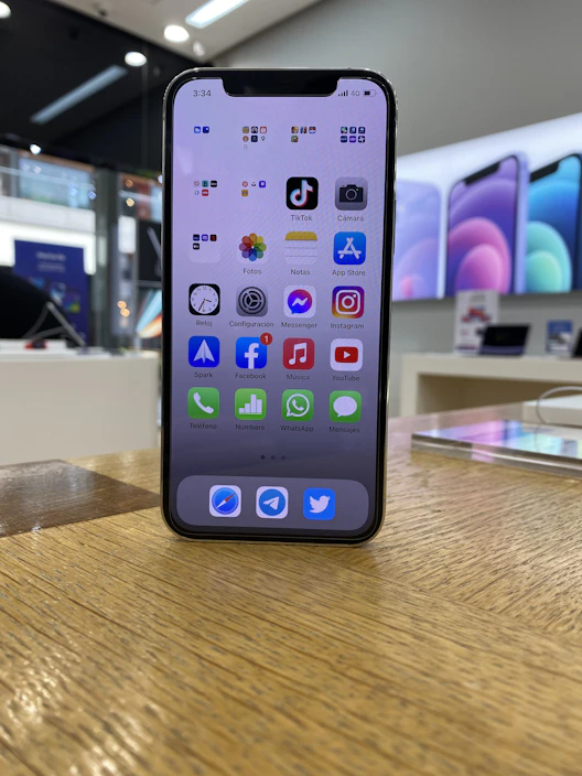 A sleek smartphone displaying the Aukso Sparnas app store homepage with black, gold, and white accents.