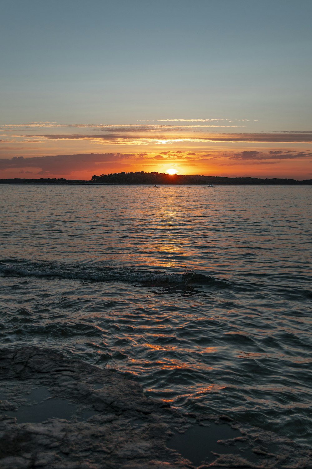 body of water during sunset