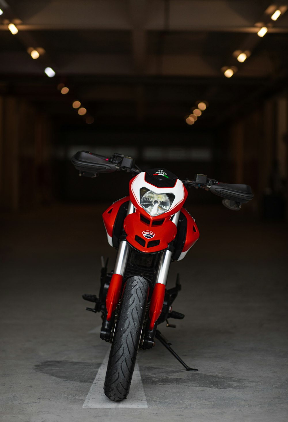 red and white motorcycle in a parking lot