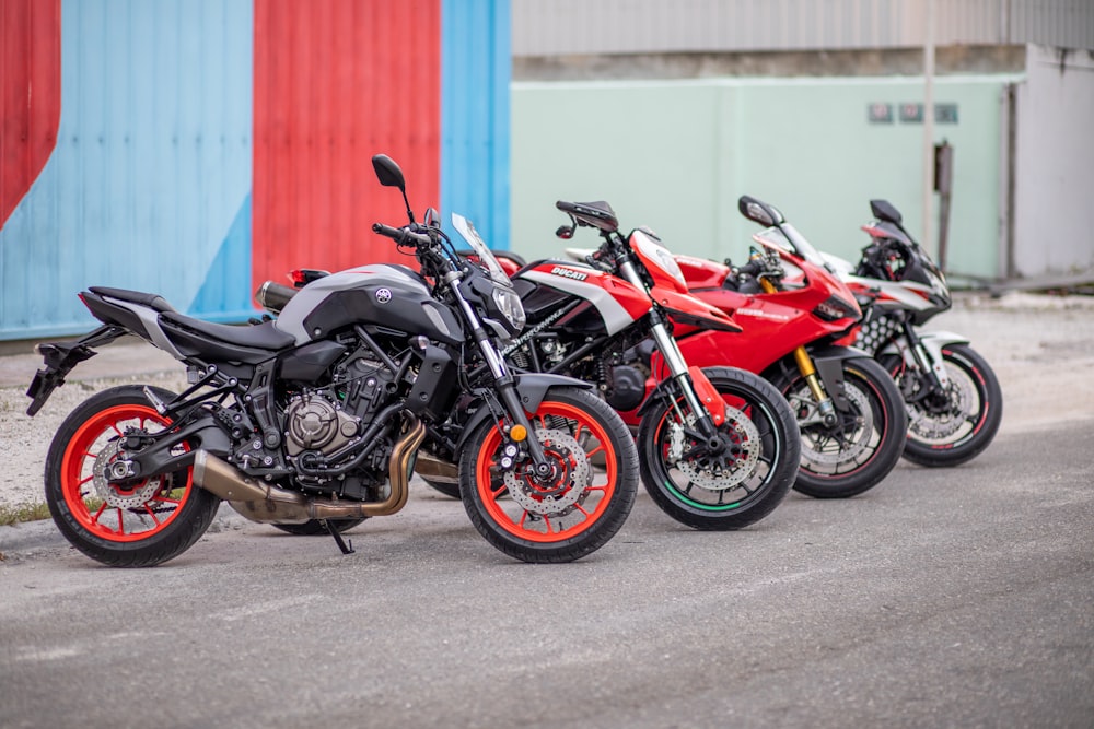 black and red sports bike parked on gray concrete road during daytime