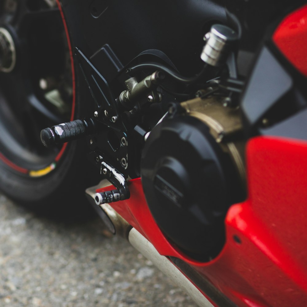 black and red motorcycle on gray concrete floor