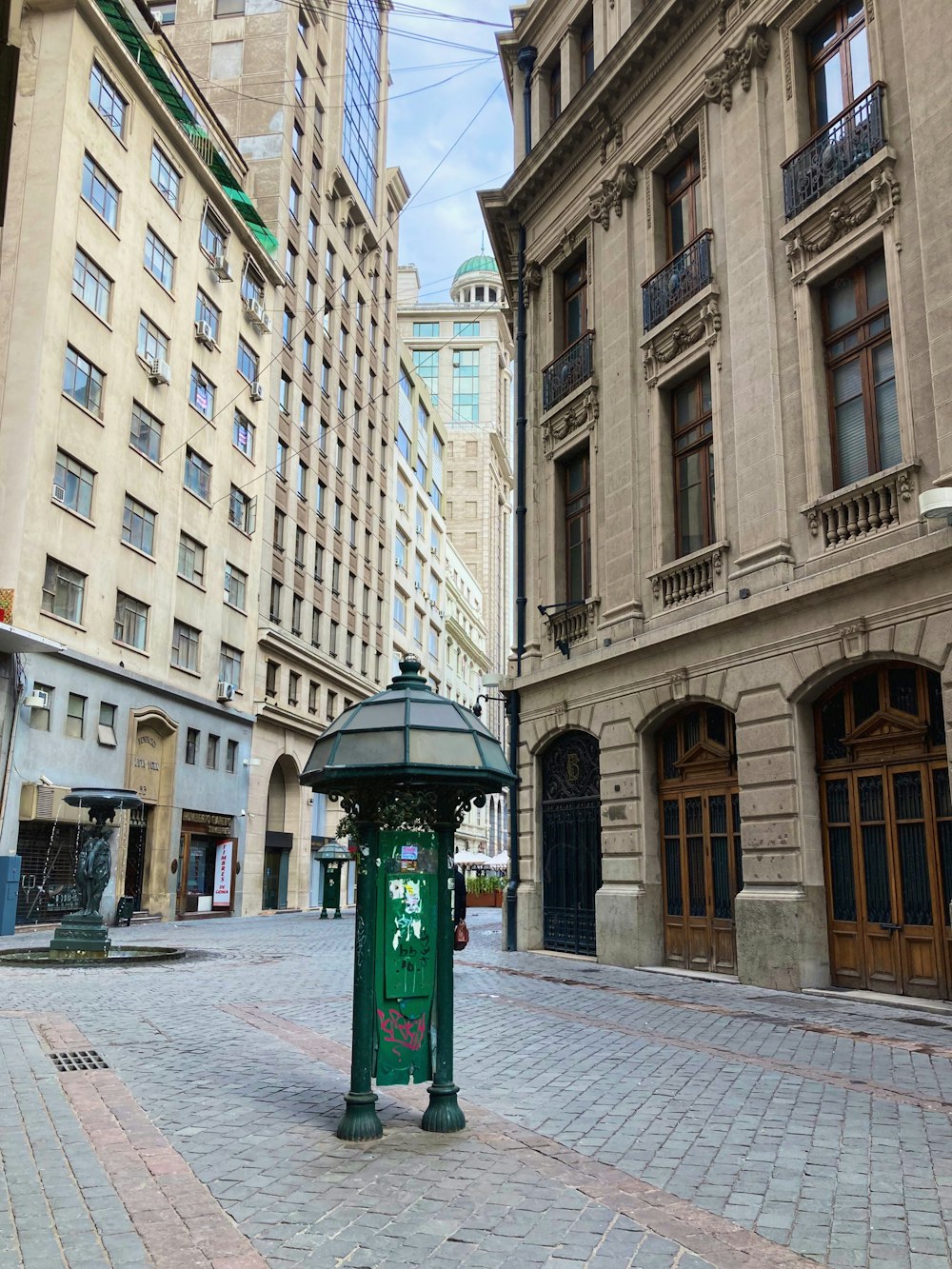 green and white street light near brown concrete building during daytime