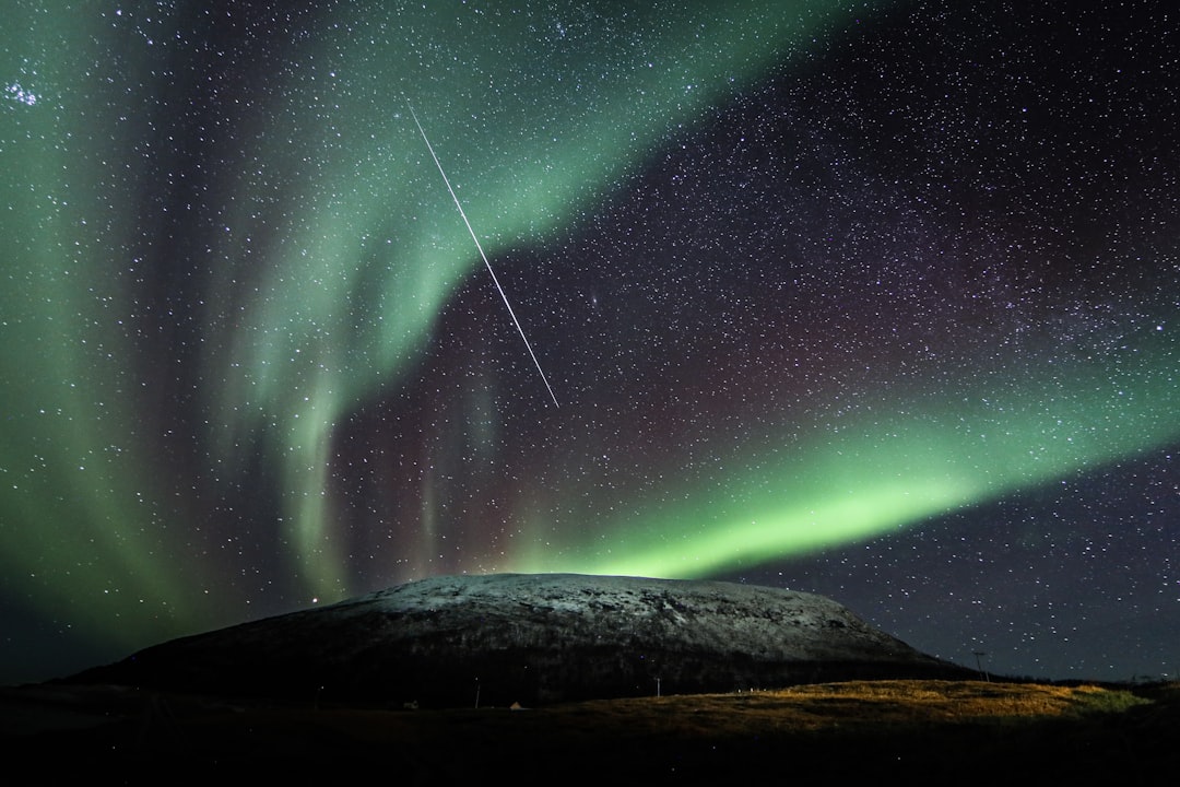 green and blue sky with stars