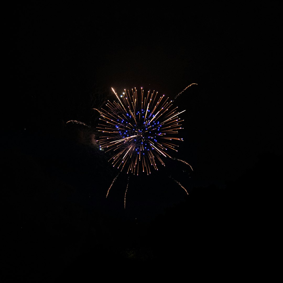 white and red fireworks in the sky during nighttime