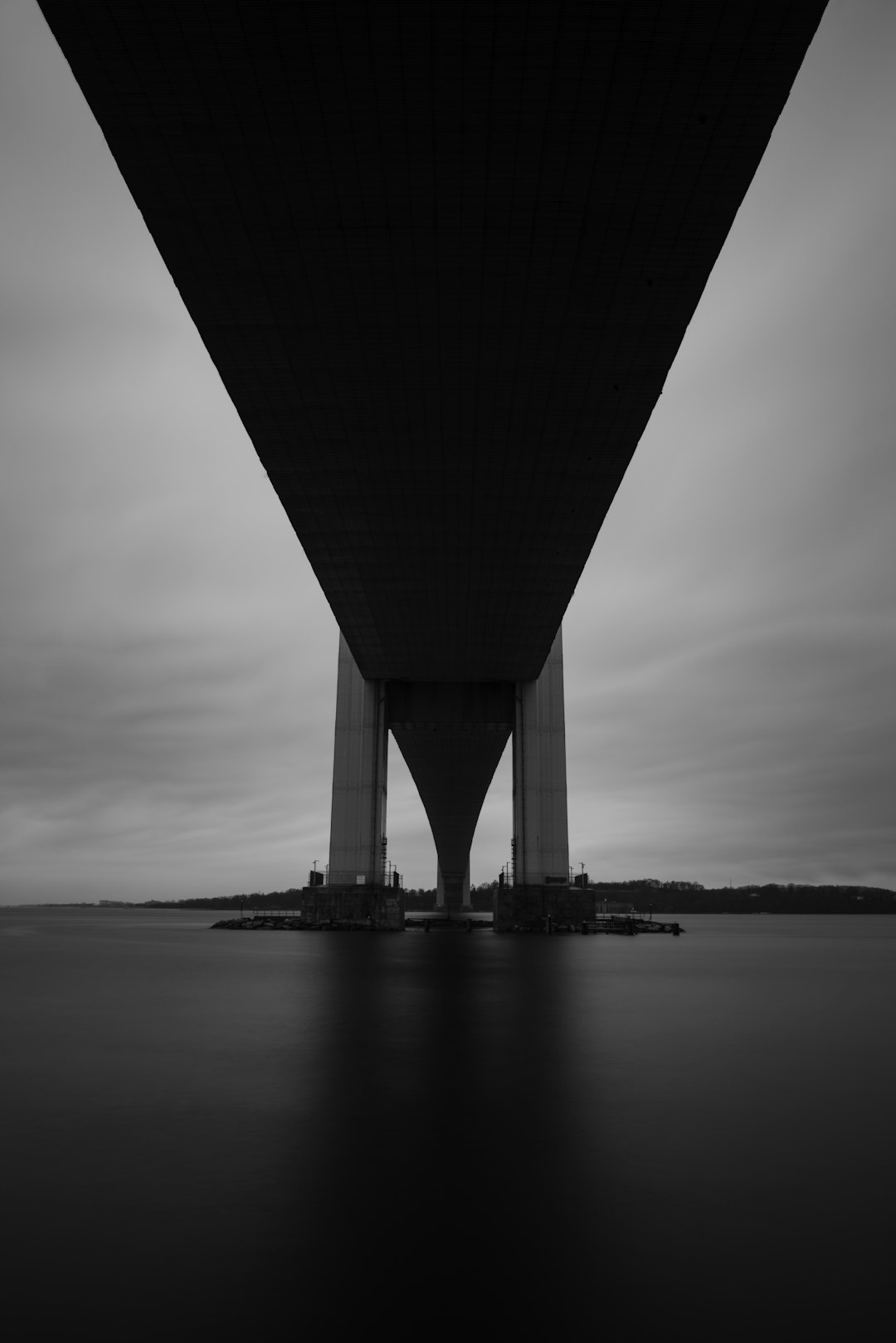 grayscale photo of bridge over body of water