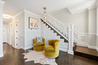 Advisor walking through a bright, modern home with yellow decorative elements