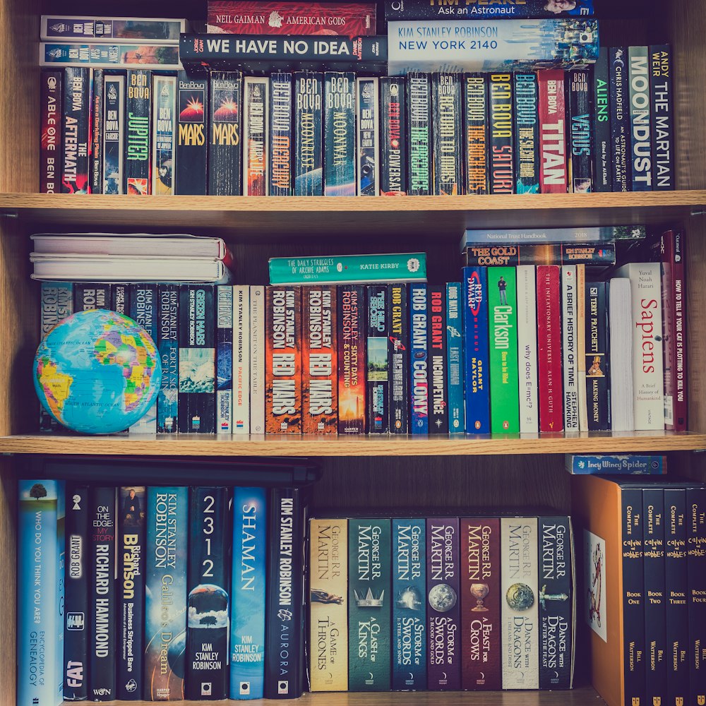 books on brown wooden shelf