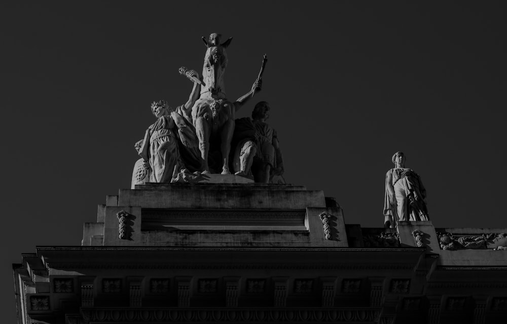 grayscale photo of man and woman statue