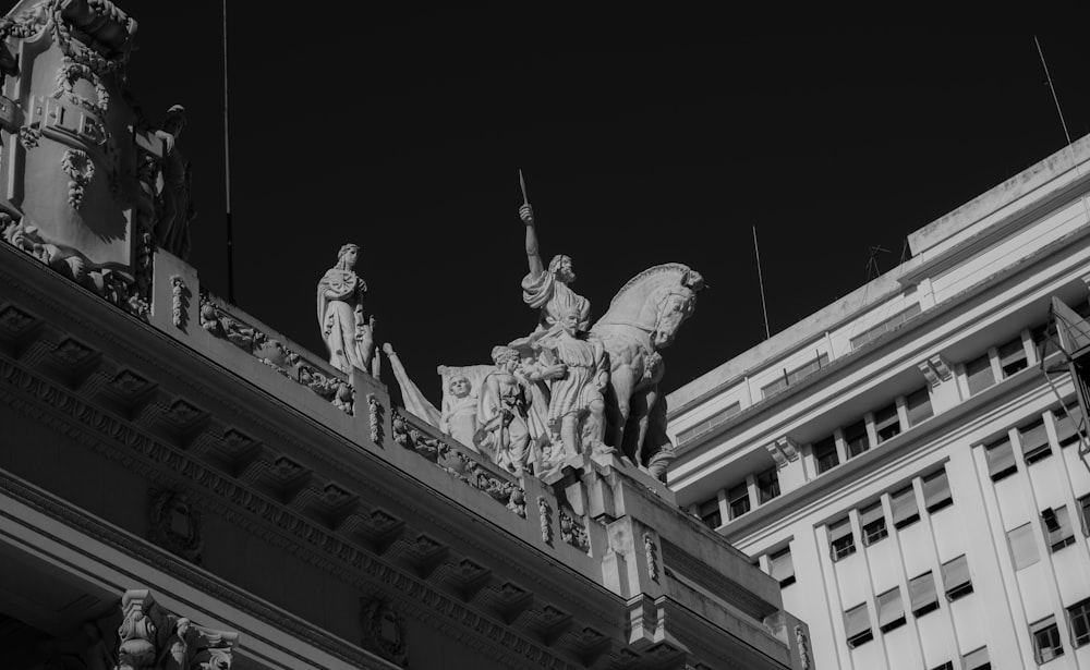 grayscale photo of man riding horse statue