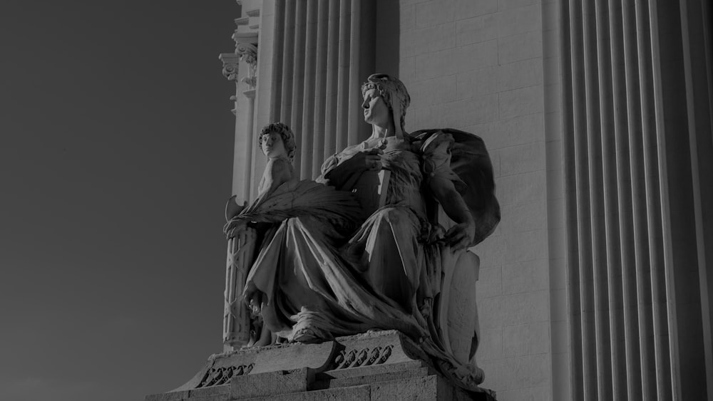woman in dress statue in grayscale photography