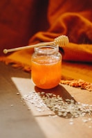 clear glass jar with orange liquid