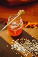 Sunlit scene of a honey tasting set with spoons and fresh bread slices.