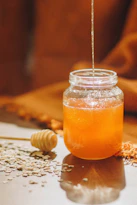 clear glass jar with orange liquid