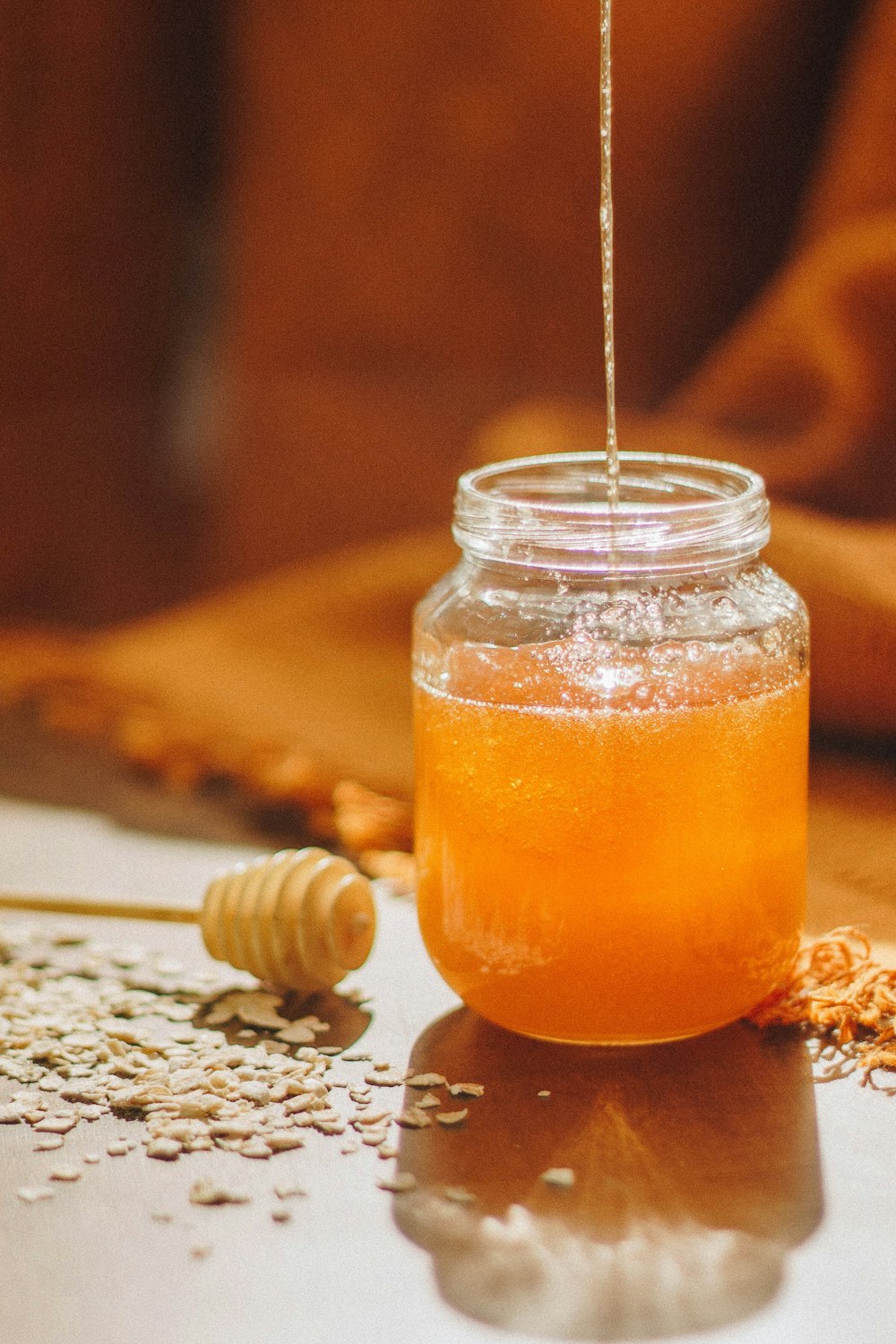 clear glass jar with orange liquid