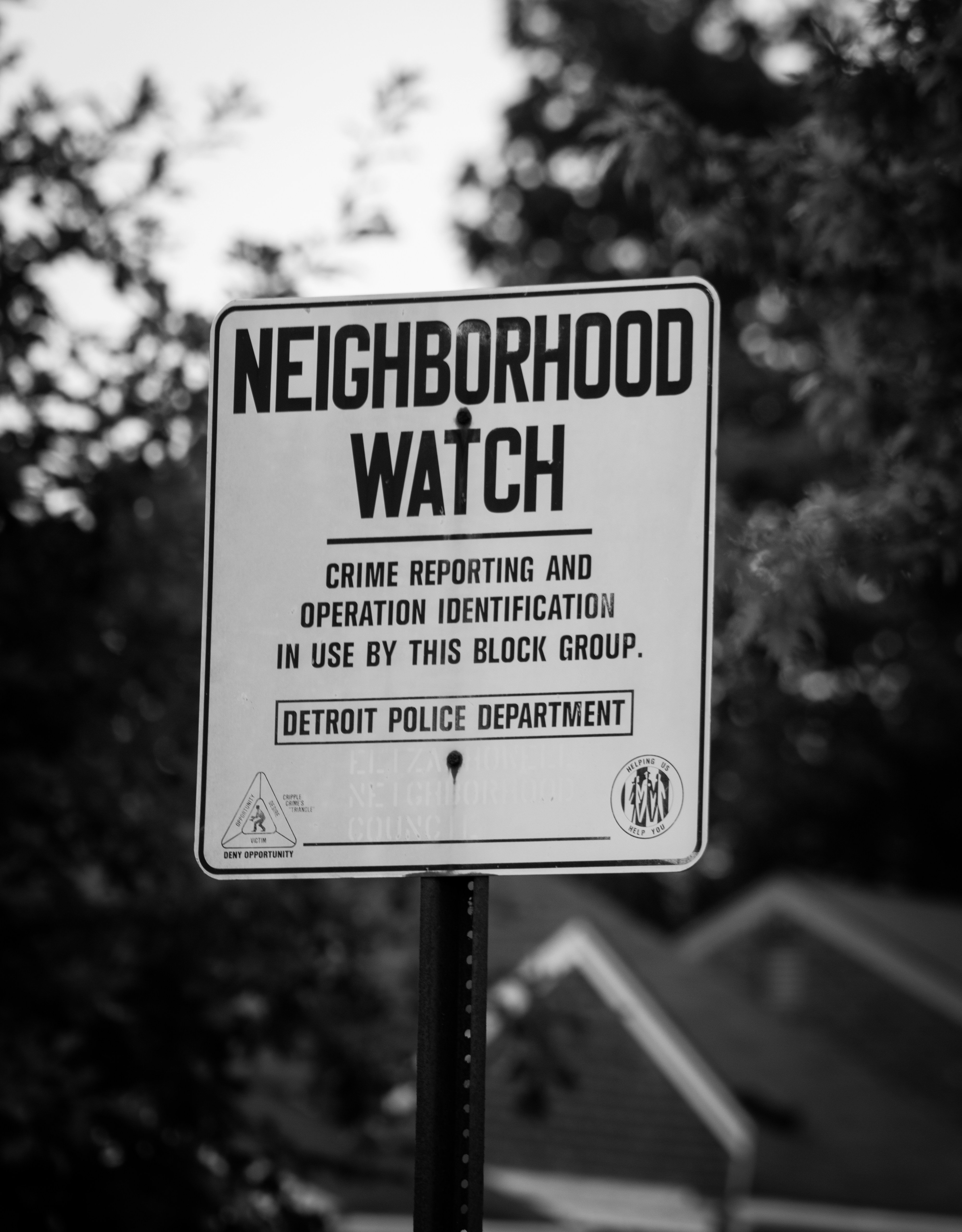 a neighborhood watch sign posted on a pole