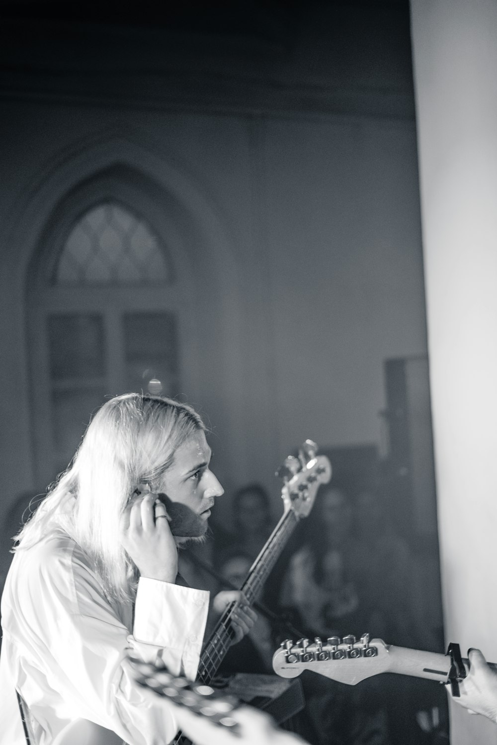 woman playing guitar in grayscale photography