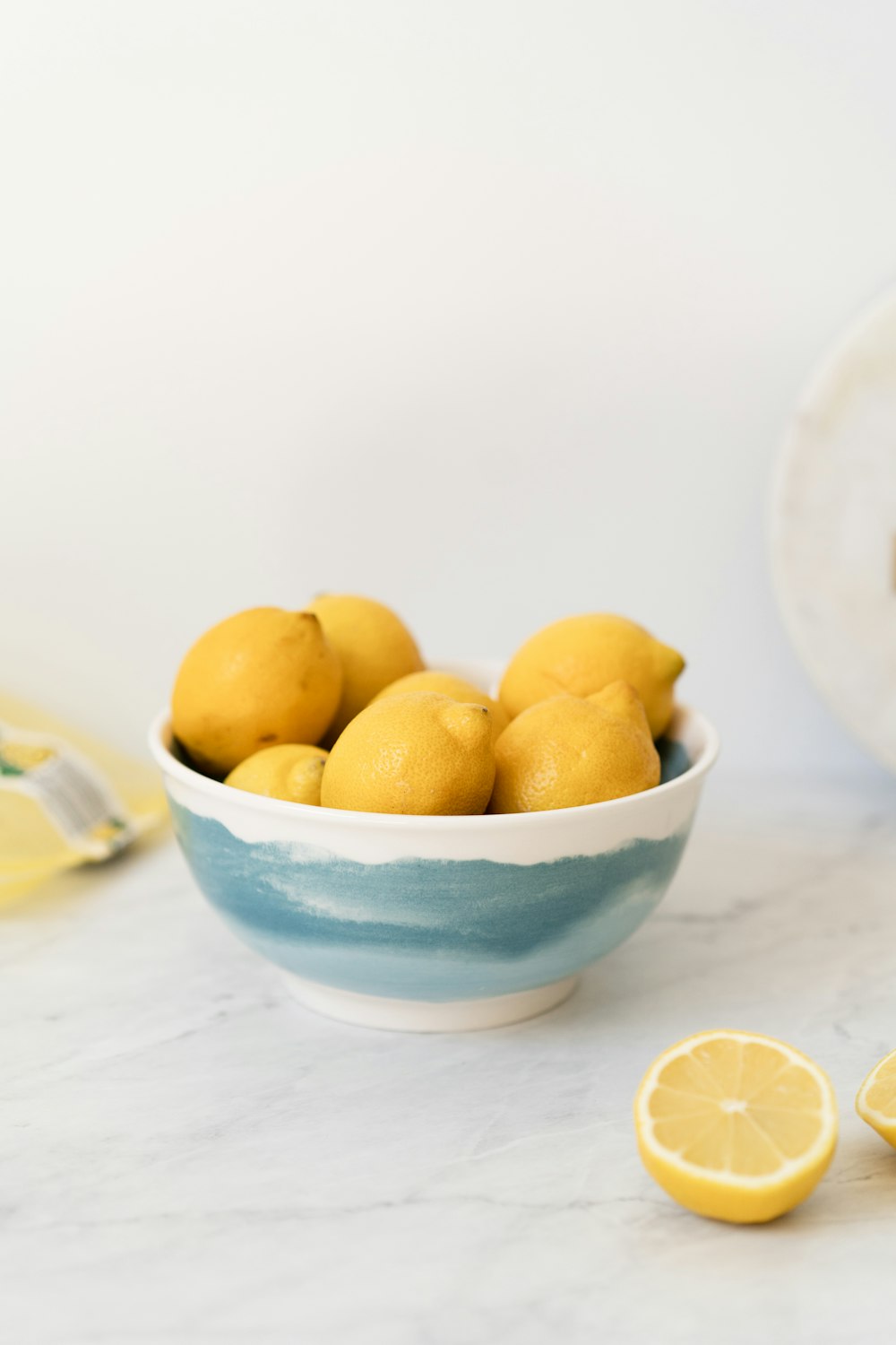 yellow fruits in blue and white ceramic bowl