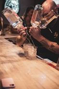 person holding clear drinking glass