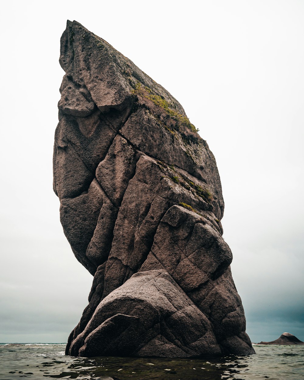 brown rock formation near body of water during daytime