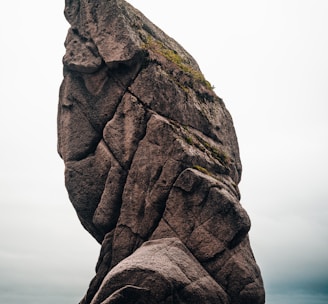 brown rock formation near body of water during daytime