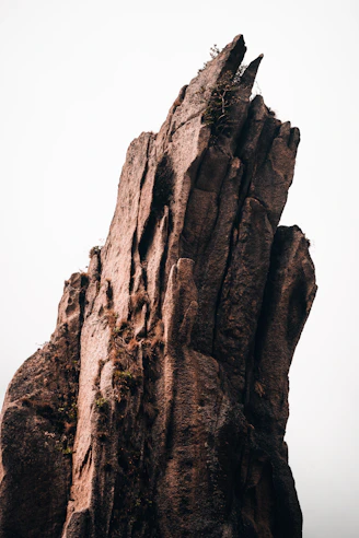 brown rock formation under white sky during daytime