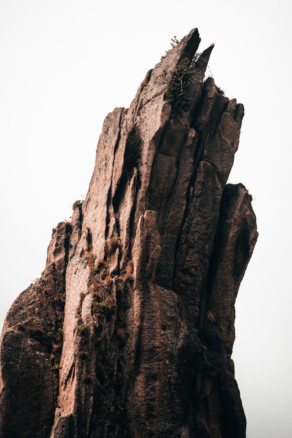 brown rock formation under white sky during daytime